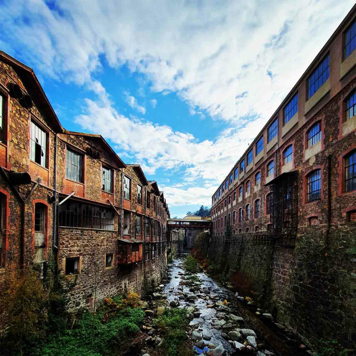 La Cance entourée des anciens bâtiments en pierre et brique de la tannerie Meyzonnier.